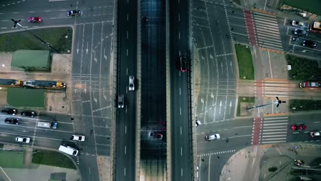 Top-down-night-city-roads-with-cars-driving-aerial-view