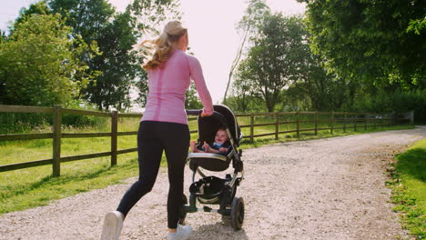Mother-Exercising-By-Running-Whilst-Pushing-Baby-Buggy