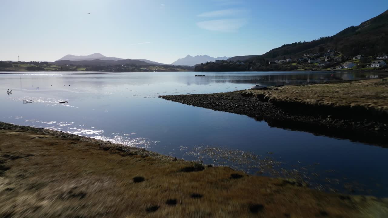 해안선 위를 낮게 비행한 다음 portree is of skye scotland의 항구 상공을 비행합니다.