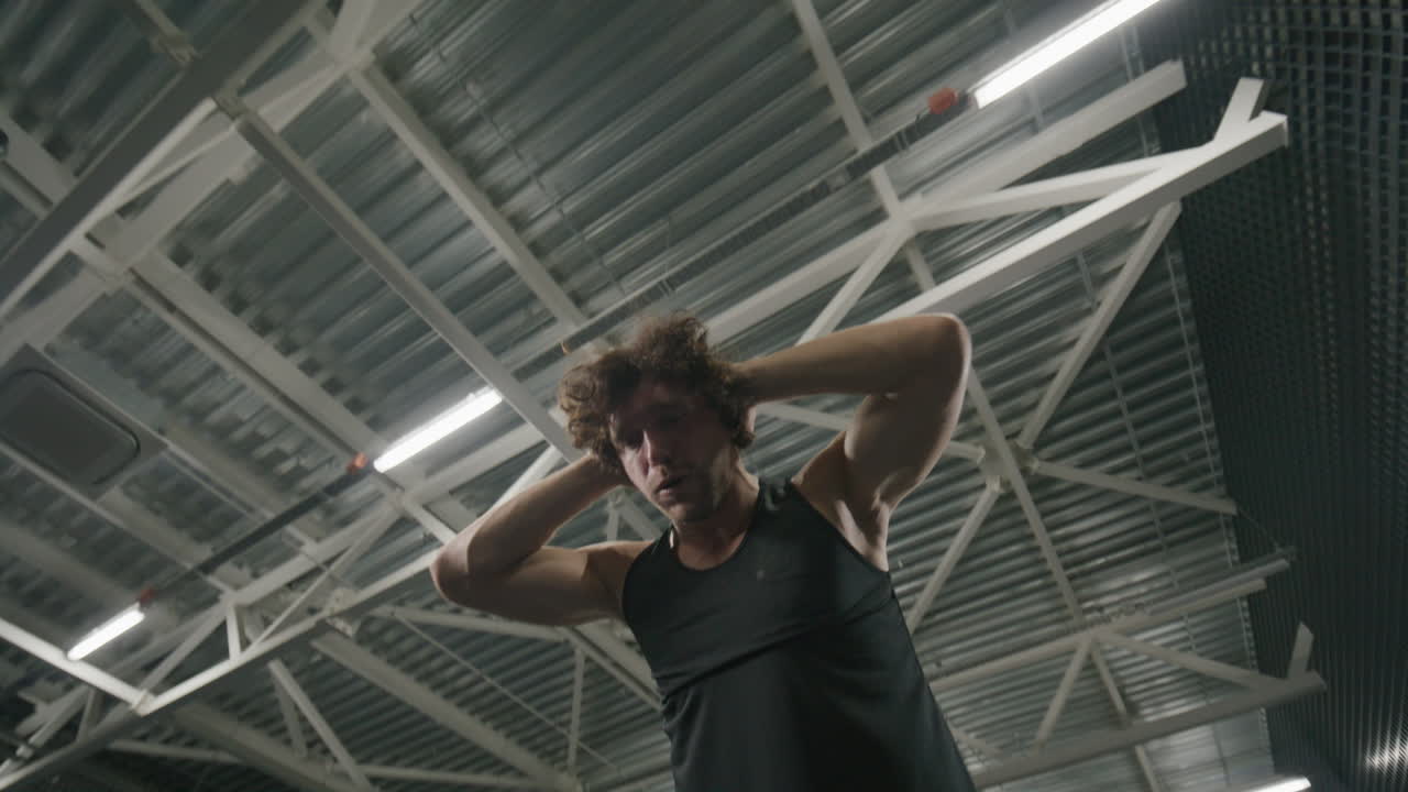 Muscular Man Performing Roman Chair Back Extensions in Gym