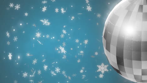 animation of mirror disco ball spinning over snow falling on blue background