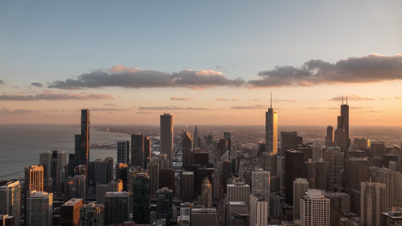 Day to night time lapse looking South at the Chicago skyline with passing clouds flowing by