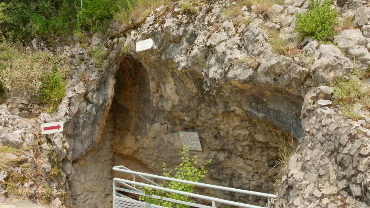 Exterior view showing the rocky entrance of the Labouiche underground river cave in Ariège, France