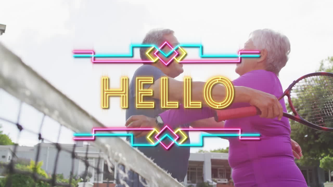 senior couple hugging on tennis court displaying neon HELLO overlay, boosting sports marketing