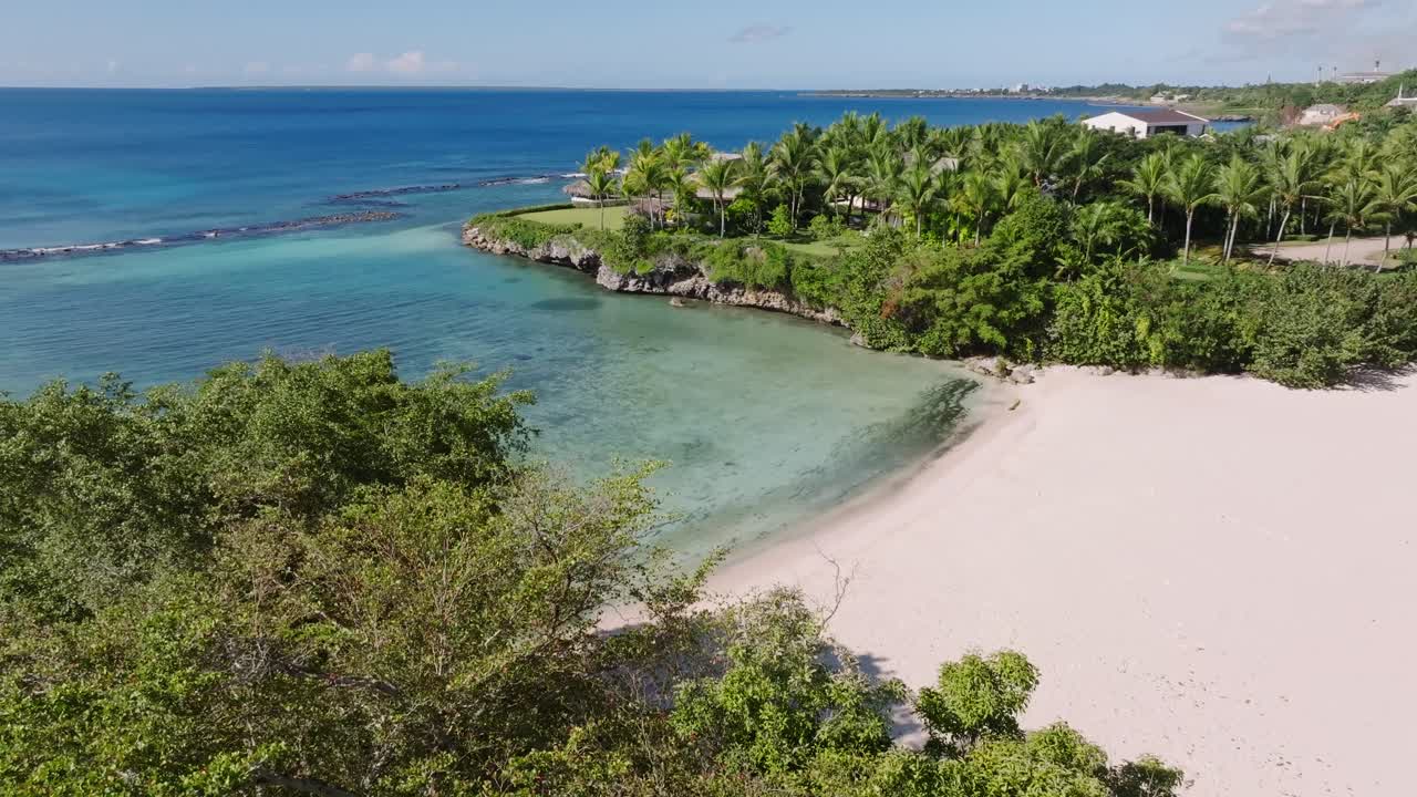 White Sandy Beach Playa Caleton With Lush Vegetation On Shore Of La Romana, Dominican Republic. aerial ascend