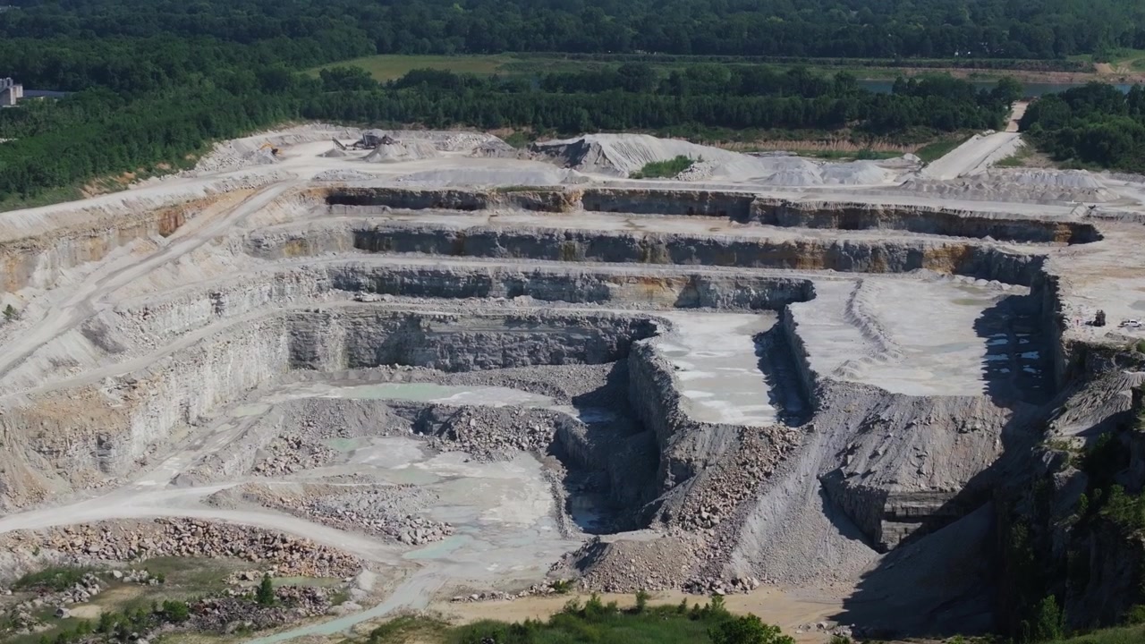 Terraced Levels of an Open Pit Limestone Quarry - Forward Drone Shot