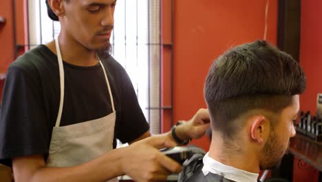 Man-getting-his-hair-cut-by-hairdresser-4k