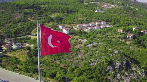 turkish flag waving over a mountain town