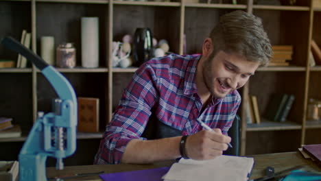 Happy business owner working in workshop