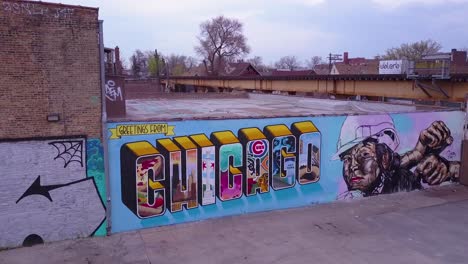 An-aerial-over-a-downtown-Chicago-sign-painted-on-a-wall-as-an-El-train-passes-