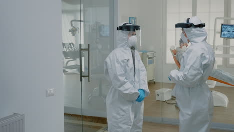 stomatological doctors wearing ppe suits at dental clinic