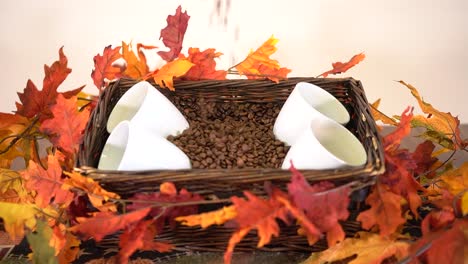 Slow-motion,-coffee-beans-dropping-into-basket-of-coffee-supplies