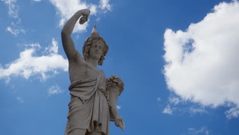 low angle view of roman statue with pigeon on head and moving clouds in rome italy roma italia