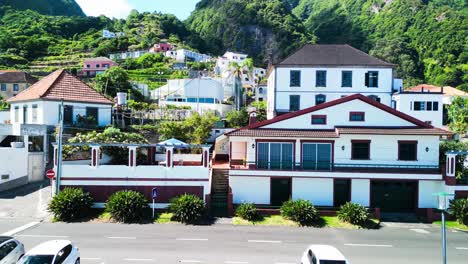 up close of houses of seixal village with mountains in the background in portugal