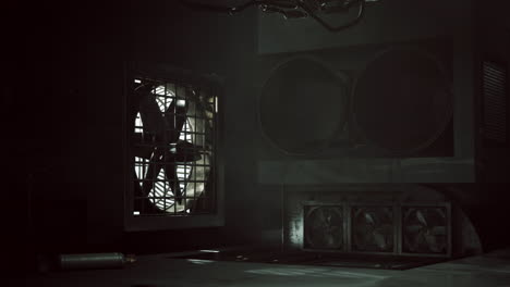 dark and industrial room with fans