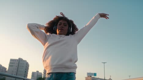 Black-woman-dancing-on-the-bridge-and-looking-at-camera