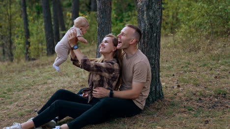 happy family with baby in the forest