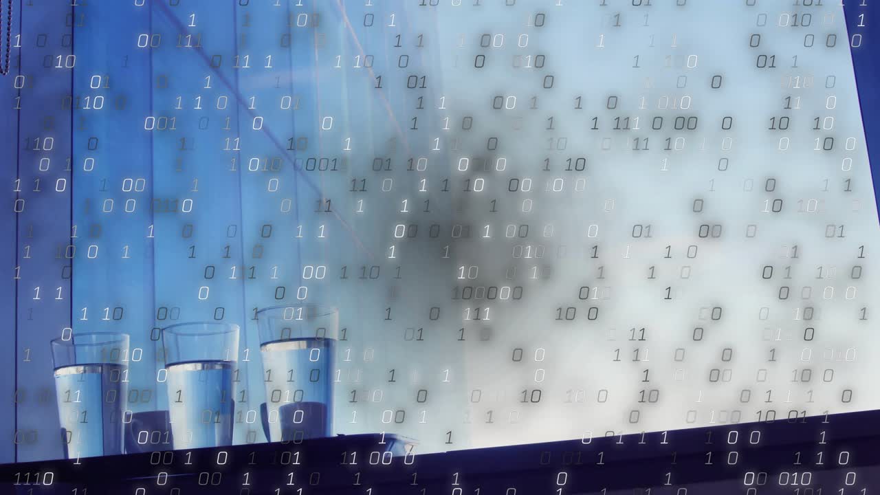 Glasses sitting ledge before binary digits emerging and cascading into digital rain over window