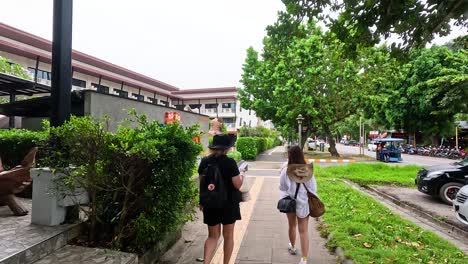 two people explore a scenic street in krabi