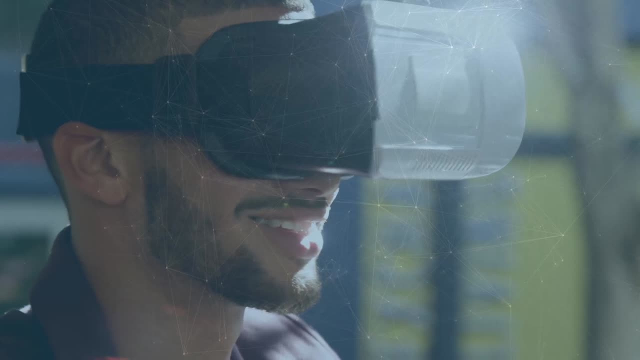 Animation of network of connections over close up of biracial man wearing vr headset at office