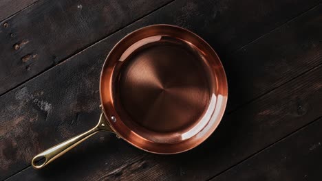 copper pan on a wooden table