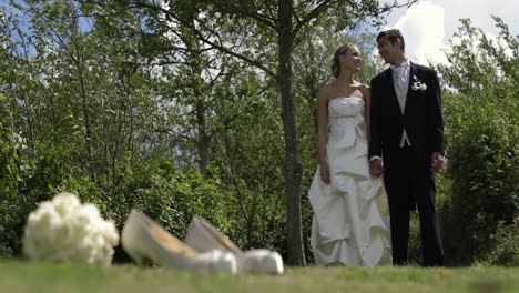Bride-and-groom-standing-outside-on-a-sunny-day