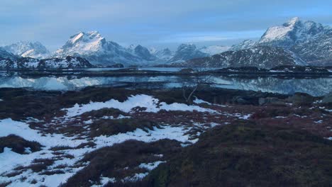 A-beautiful-snow-covered-shoreline-amidst-fjords-north-of-the-Arctic-Circle-in-Lofoten-Islands-Norway-1