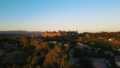 slow rising aerial shot of the medieval citadel carcassonne during sunset