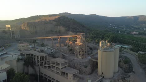 aerial view of an industrial quarry or cement plant in a hilly landscape
