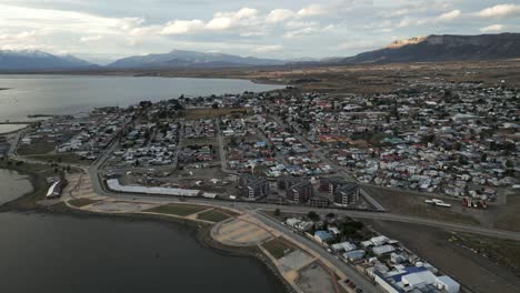 Puerto-Natales-Chile-Aerial-View,-Torres-del-Paine-National-Park,-Cityscape,-Town,-Streets,-Montt-Gulf-Water-and-Port-during-Summer-Daylight