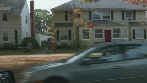 driving past a historic neighborhood at fall time