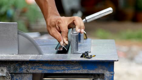 Professional Worker cutting aluminium with grinder blade