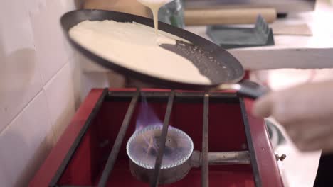 woman preparing pancakes on pan