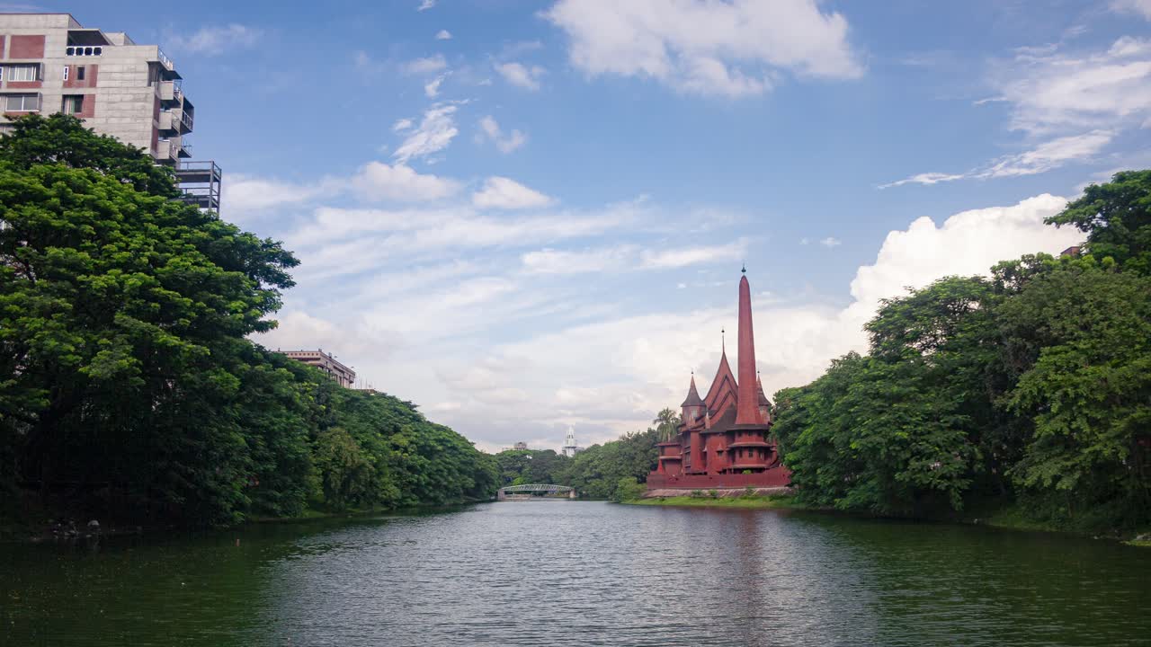 A closer timelapse shot of Dhanmondi Lake in Dhaka, featuring the iconic Ship House before its demolition, with moving clouds enhancing the scene.