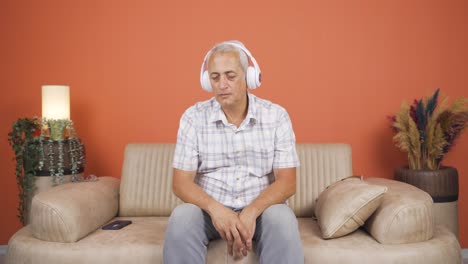 Man-listening-to-music-with-headphones-is-unhappy-and-sad.