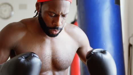 male boxer in aggressive mood in fitness studio 4k