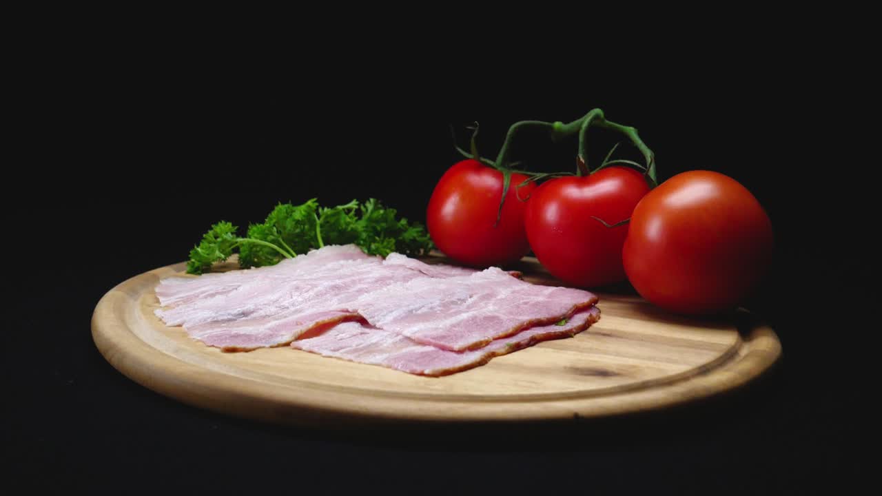 Bacon and Tomatoes on a Wooden Cutting Board