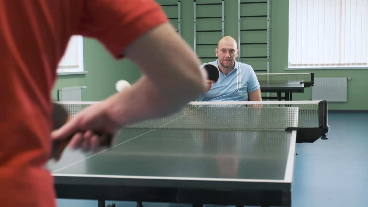 Man in Wheelchair Playing Table Tennis
