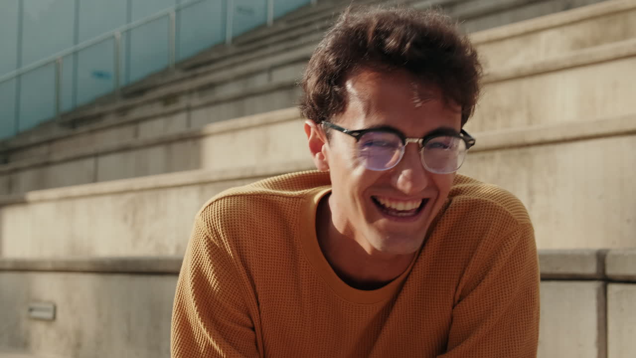 Close up of cheerful young student tells stories to his friends