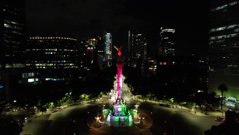 drone shot of angel de la independencia iluminated at night during dia de la independencia