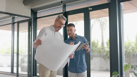 diverse business colleagues having drinks and talking to each other in the balcony at office