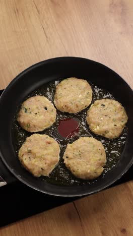 frying chicken patties in a pan