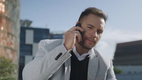 businessman having phone conversation at street