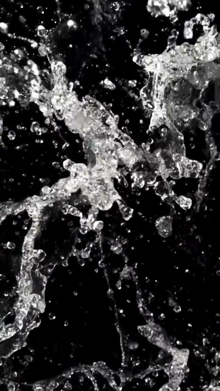 Clear Water Splashing and Droplets Against a Black Background