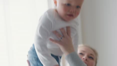 happy mother playing with baby at home smiling enjoying motherhood playfully caring for cute toddler