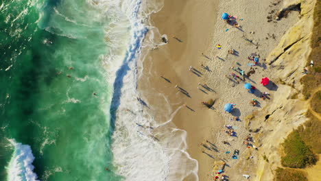 Aerial-static-over-beach-goers-in-La-Jolla,-California