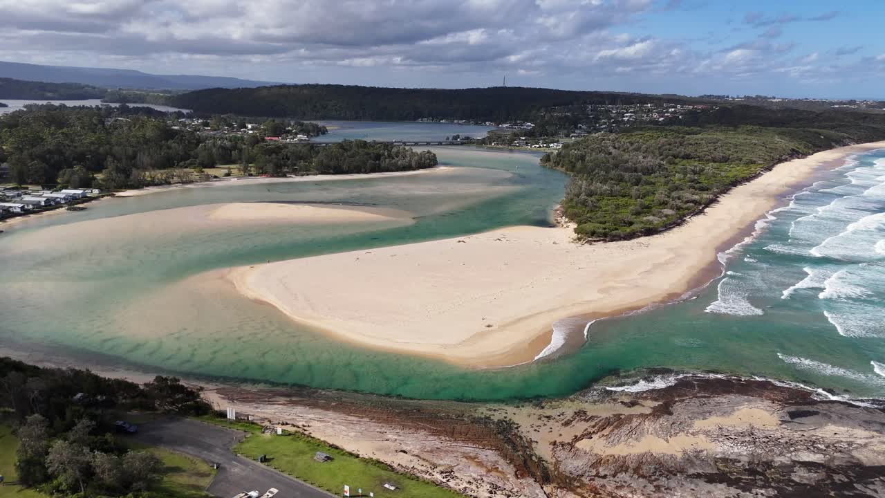Wide drone panorama of Dolphin Point Beach and surrounding coastal landscape, orbit clockwise