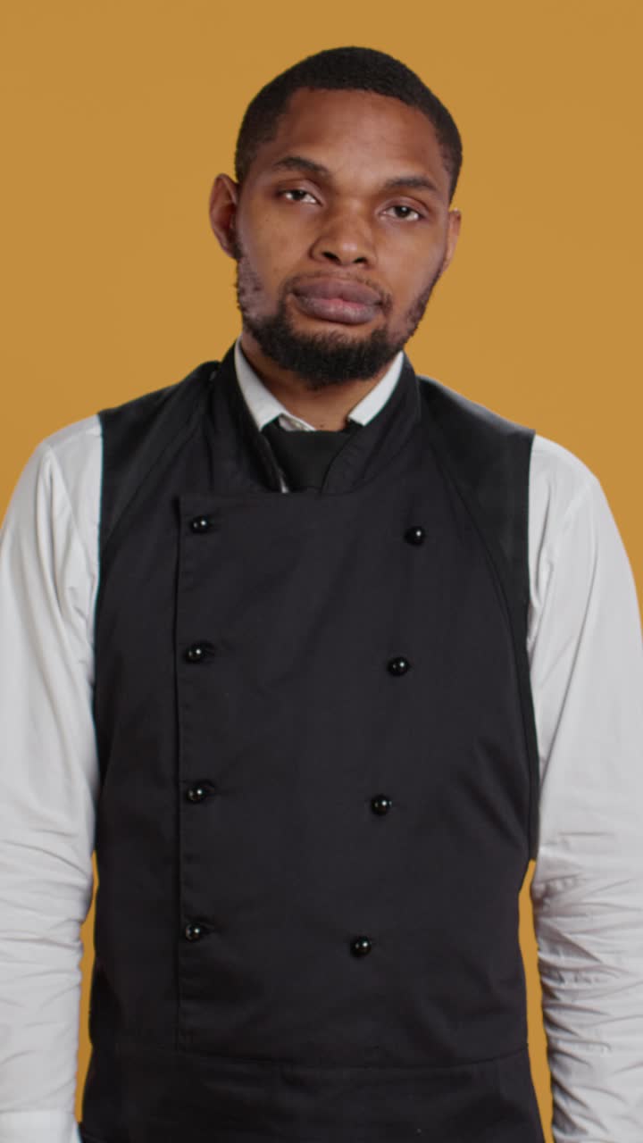 Professional Chef Holding Spice Rack and Making Chef's Kiss Gesture
