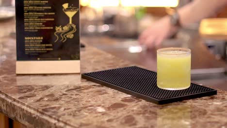 bartender serves a cocktail to a customer