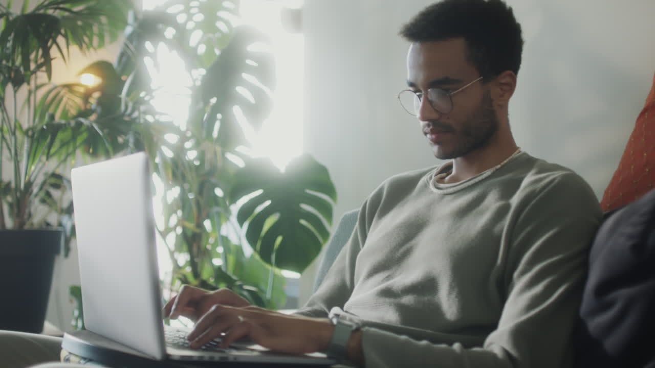 Man Working on Laptop at Home